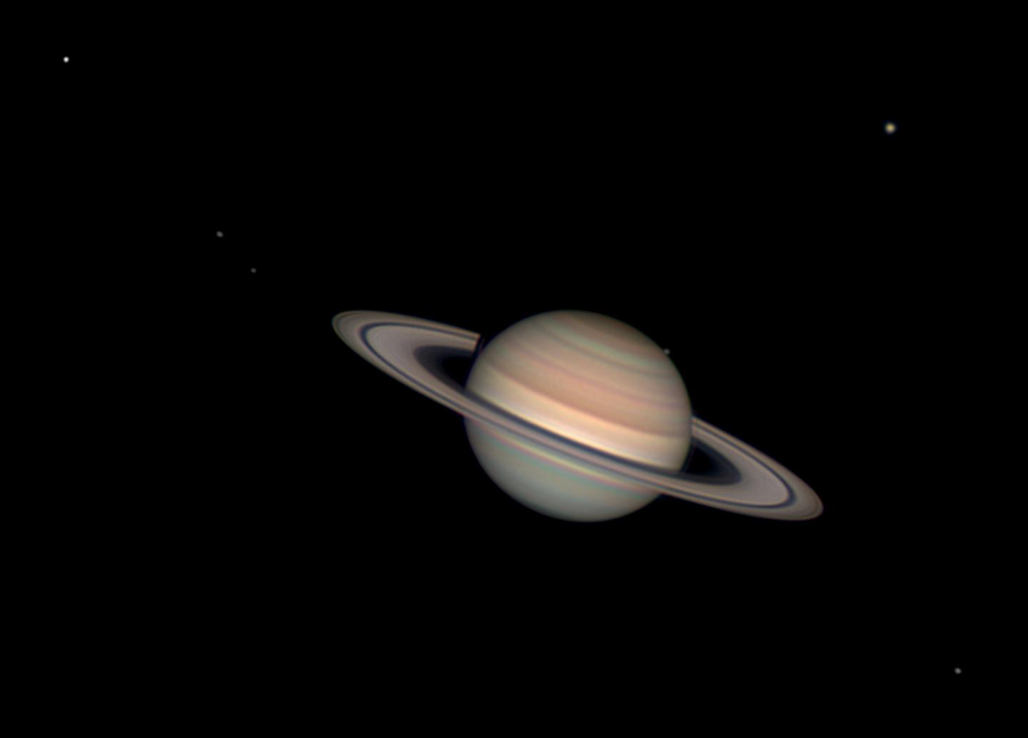 Image of Saturn, a round yellow-brown planet with thin rings around it. It is tilted at a slight angle.